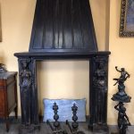 Antique carved fireplace in oak with caryatid figures and chimney hood