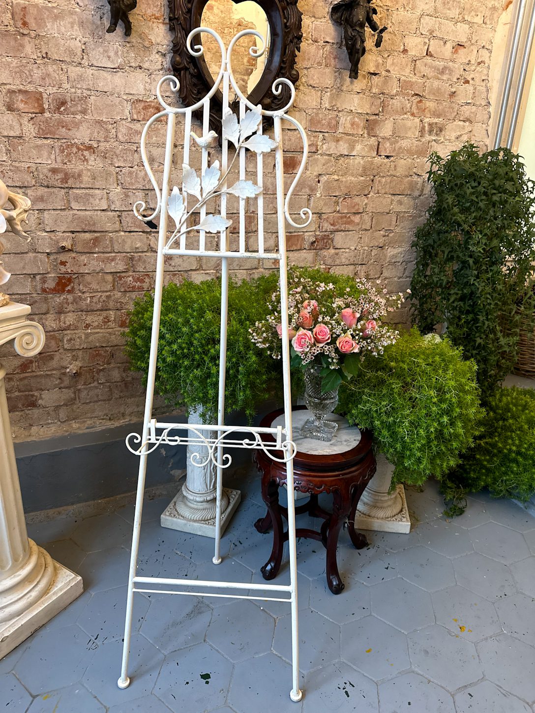 IMG_0100 2 Antique style white wrought iron easel stand with sculpted metal songbird and leafy branches showing adjustable picture display frame in a traditional European parlor interior.