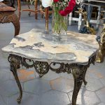 Small ornate coffee table with onyx marble top and metal base