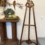 Antique French Neorococo carved wood studio display easel with ornate openwork rocaille cresting and acanthus leaf details on sweeping cabriole legs.