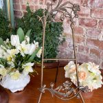 Antique Art Nouveau tabletop easel with sculpted bronze iris flowers and folding tripod stand showcasing traditional French Belle Epoque decorative metalwork.