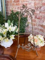 Antique Art Nouveau tabletop easel with sculpted bronze iris flowers and folding tripod stand showcasing traditional French Belle Epoque decorative metalwork.