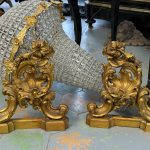Pair of antique gilt-bronze chenets with rococo shell and scrolls