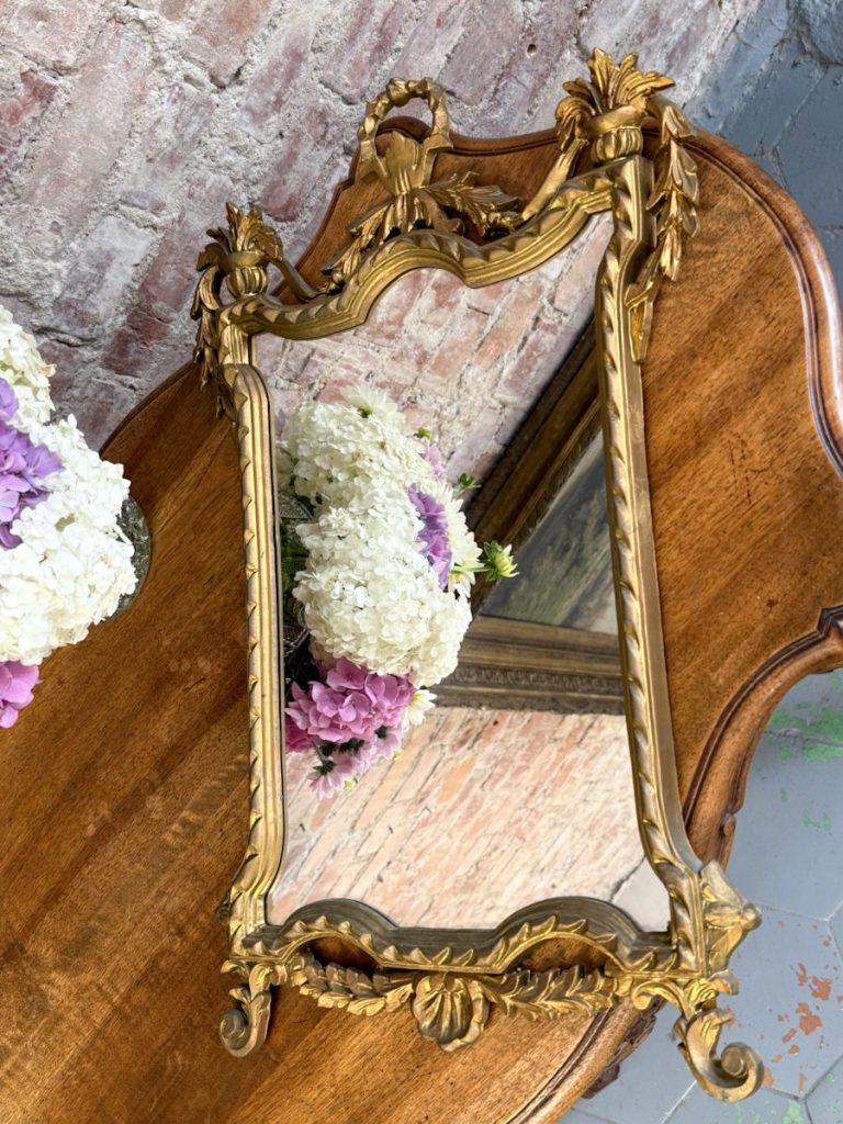 Gilt rococo wall mirror with ribbon bow crest