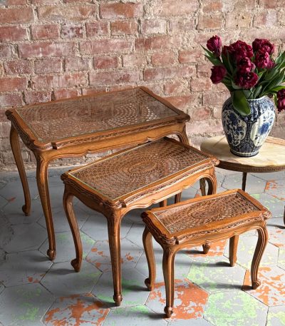 antique wooden nesting tables with caned glass tops set of three