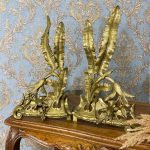 Antique bronze chenets pair with palm leaves and bird