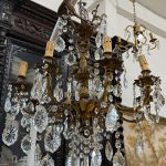 antique brass and crystal eight arm chandelier with cherub angels detailing