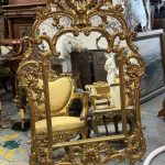 Antique French Rococo style large gilt cushion mirror featuring a monumental openwork rocaille shell crown