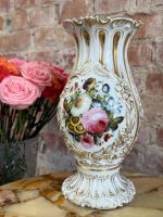 Ornate French porcelain vase with hand-painted floral bouquets and gold relief detailing