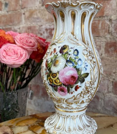 Ornate French porcelain vase with hand-painted floral bouquets and gold relief detailing