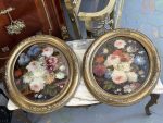 pair of antique oval floral oil paintings under glass in ornate gilt frames