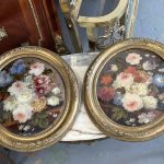 pair of antique oval floral oil paintings under glass in ornate gilt frames