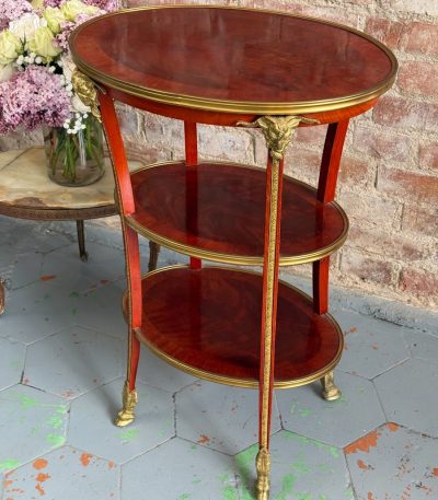 Antique Louis XVI style mahogany three-tier side table with bronze ram heads
