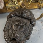 Antique cast iron coalbox with grotesque mask and shell relief