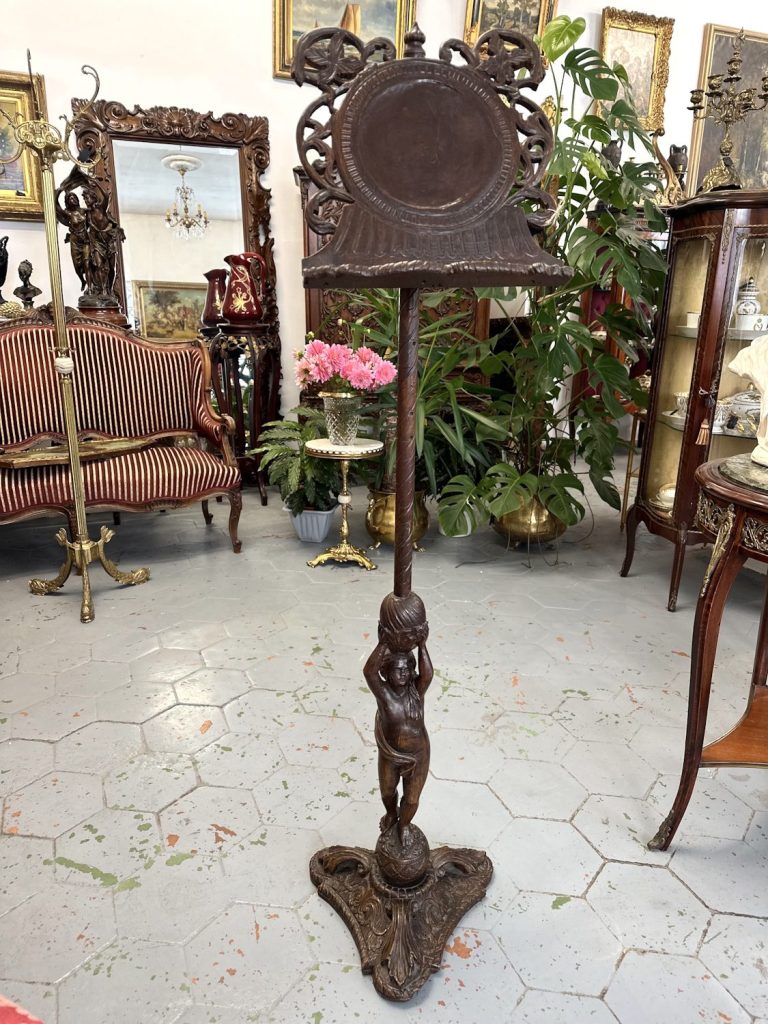 Antique hand carved wood lectern music stand featuring a detailed cherub angel holding a twisted column on an ornate tripod base.