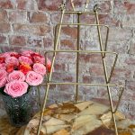 Vintage mid-century brass tabletop display easel detailed with cast horse heads