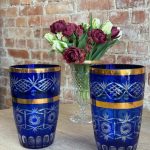 Cobalt blue cut-to-clear crystal vase with wide gold bands and star cut patterns