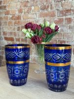 Cobalt blue cut-to-clear crystal vase with wide gold bands and star cut patterns