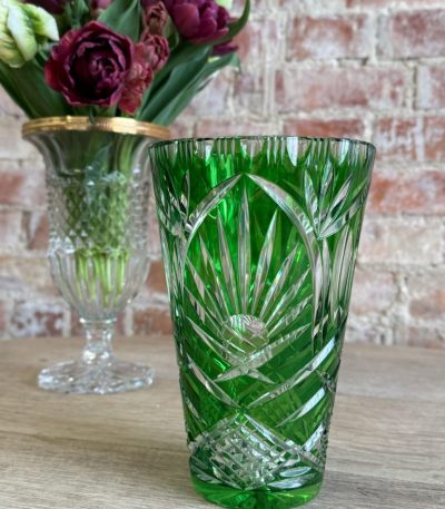 Vibrant emerald green cut-to-clear crystal vase with classic star and diamond patterns