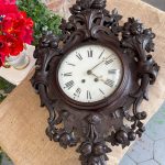 antique wall clock with wood carvings