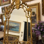 Antique French Rococo style large gilt cushion mirror with an ornate openwork shell crown