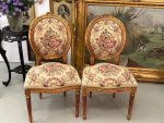 antique gilded chairs with pastoral tapestry duo