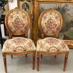 antique gilded chairs with pastoral tapestry duo