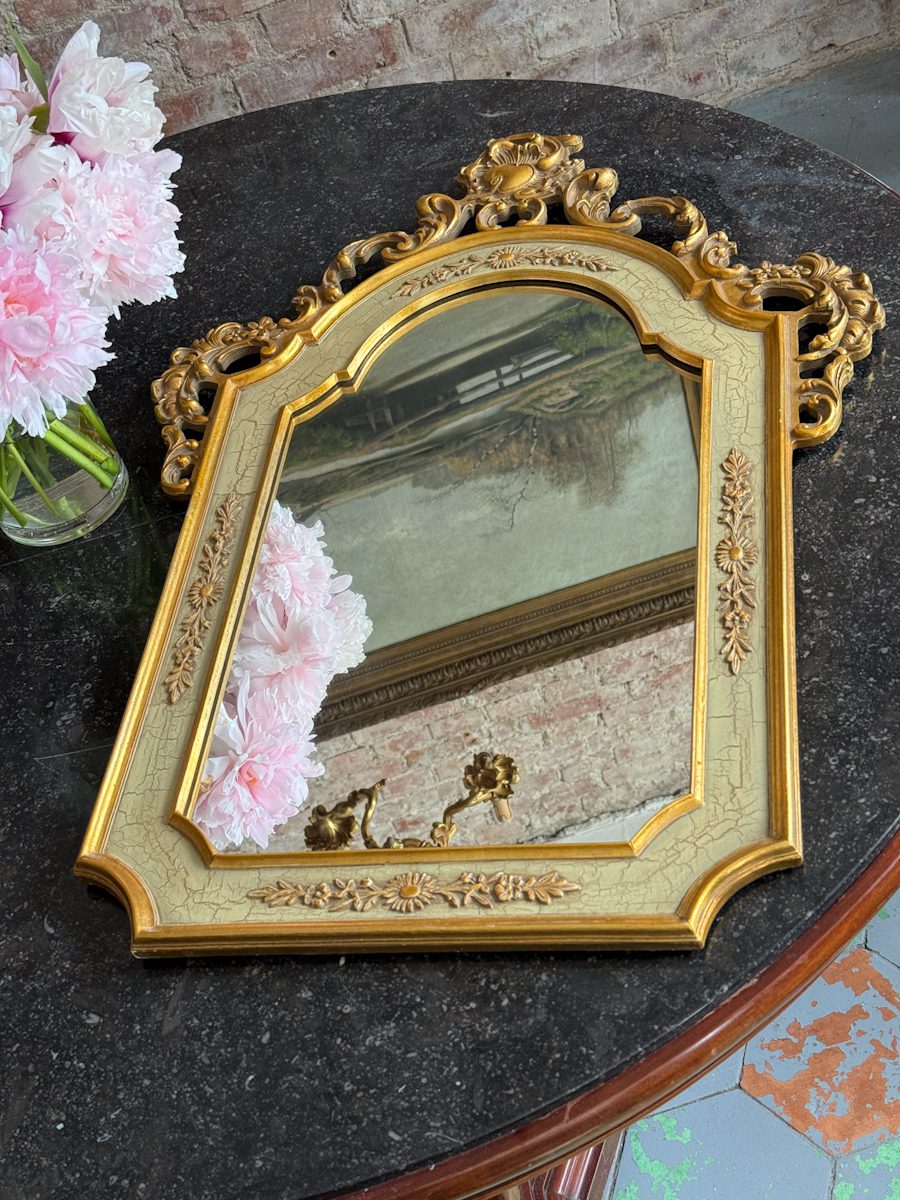 IMG_3607 Elegant gilt neo-rococo wall mirror featuring a wooden frame with floral scrolls and a pastel green craquelure finish.