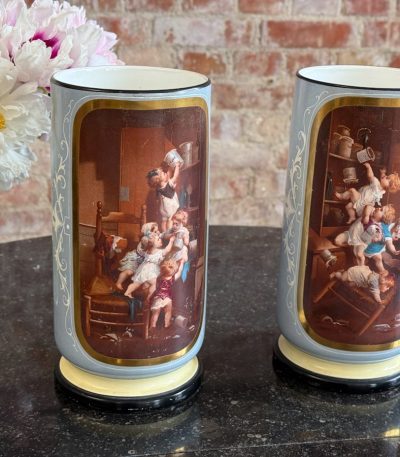 2 medium size porcelain vases with painted putti scenes