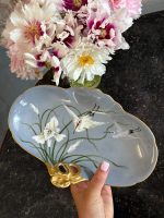 Beautiful light blue limoges porcelain stork dish with hand-painted irises and a gold handle in Art Nouveau style.