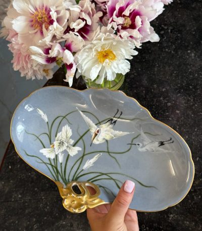Beautiful light blue limoges porcelain stork dish with hand-painted irises and a gold handle in Art Nouveau style.