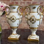 Pair of Limoges porcelain urn vases in French Empire style with swan handles and Napoleonic bees