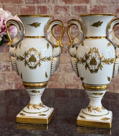 Pair of Limoges porcelain urn vases in French Empire style with swan handles and Napoleonic bees