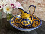 Bright yellow and blue hand-painted ceramic majolica pitcher and basin set with floral motifs in Majolica style.