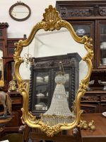 Vintage gold rococo mirror in Louis XV style with flowing acanthus leaves and shell crest
