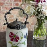 Antique hand-painted biscuit jar with floral motifs and metal lid