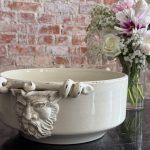 large antique faience bowl in cream color with grotesque mascaron handles