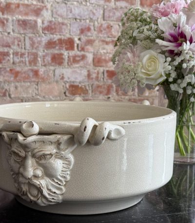 large antique faience bowl in cream color with grotesque mascaron handles