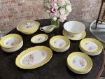 Large 24-piece dinner service with yellow borders and floral motifs