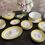 Large 24-piece dinner service with yellow borders and floral motifs