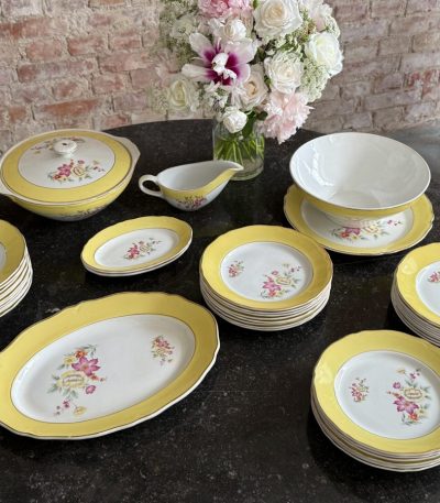 Large 24-piece dinner service with yellow borders and floral motifs