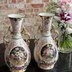 Antique porcelain vases with floral motifs and gold accents pairs