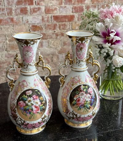 Antique porcelain vases with floral motifs and gold accents pairs