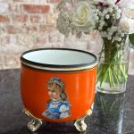 orange porcelain planter in Biedermeier and Neo-Rococo style featuring hand painted children portraits on gilded feet`