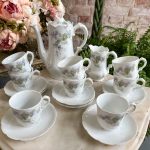 antique porcelain tea and coffee service with purple lilacs and spring flowers pattern for eight persons