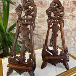 Pair of antique French Rococo style wooden easel stands with ornate pierced openwork scrolling and acanthus carvings.