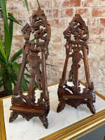 Pair of antique French Rococo style wooden easel stands with ornate pierced openwork scrolling and acanthus carvings.