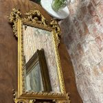 Antique rococo style gilt wall mirror with bevelled glass