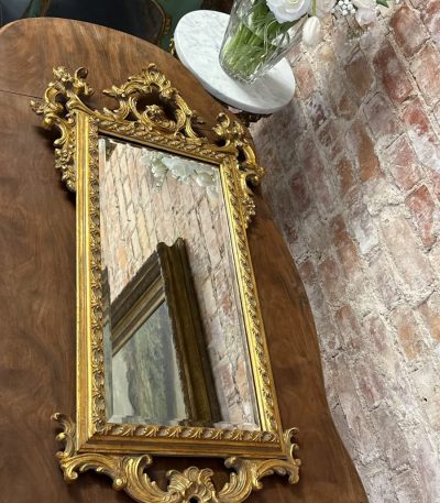 Antique rococo style gilt wall mirror with bevelled glass