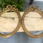 Antique pair of French oval gilt wood frames with ribbon decor